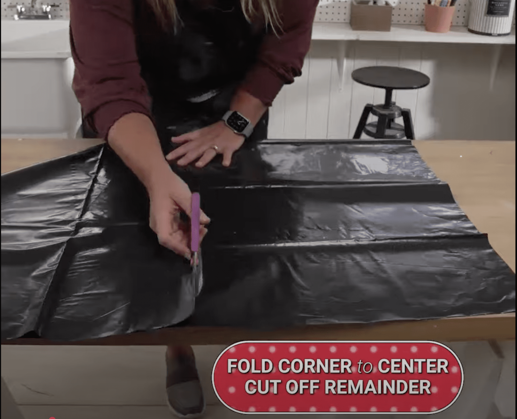 Scissors cutting trash bag
