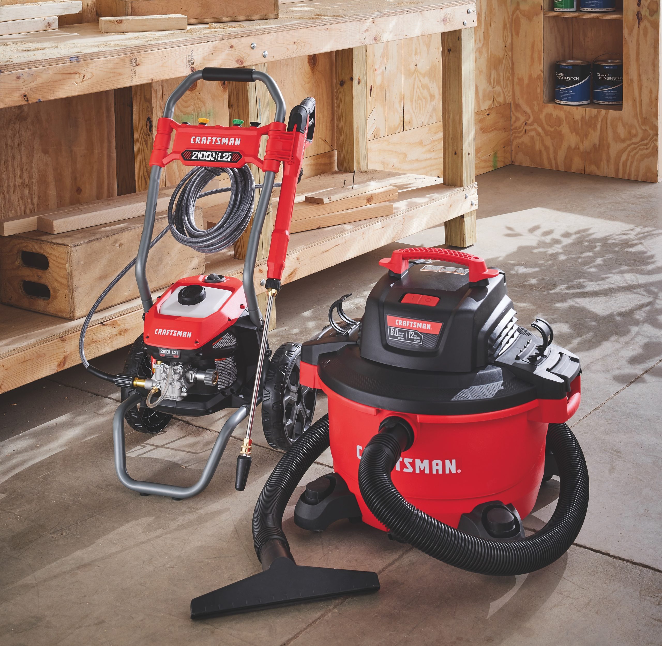 Pressure washer and shop vac in a garage.